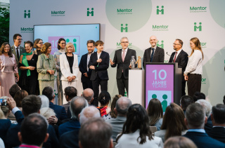 Festakt zum zehnjährigen Jubiläum der Mentor Stiftung: harald Kühl mit Gästen auf der Bühne